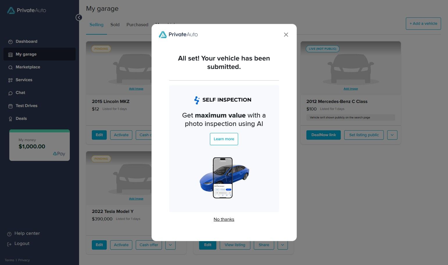 PrivateAuto confirmation popup showing vehicle submission success message. Text reads: “All set! Your vehicle has been submitted.” Below, a Self Inspection section encourages users to “Get maximum value with a photo inspection using AI.” A blue car and smartphone image illustrate the inspection process. Buttons include “Learn more” and “No thanks.” Background shows the My Garage dashboard with listed vehicles.