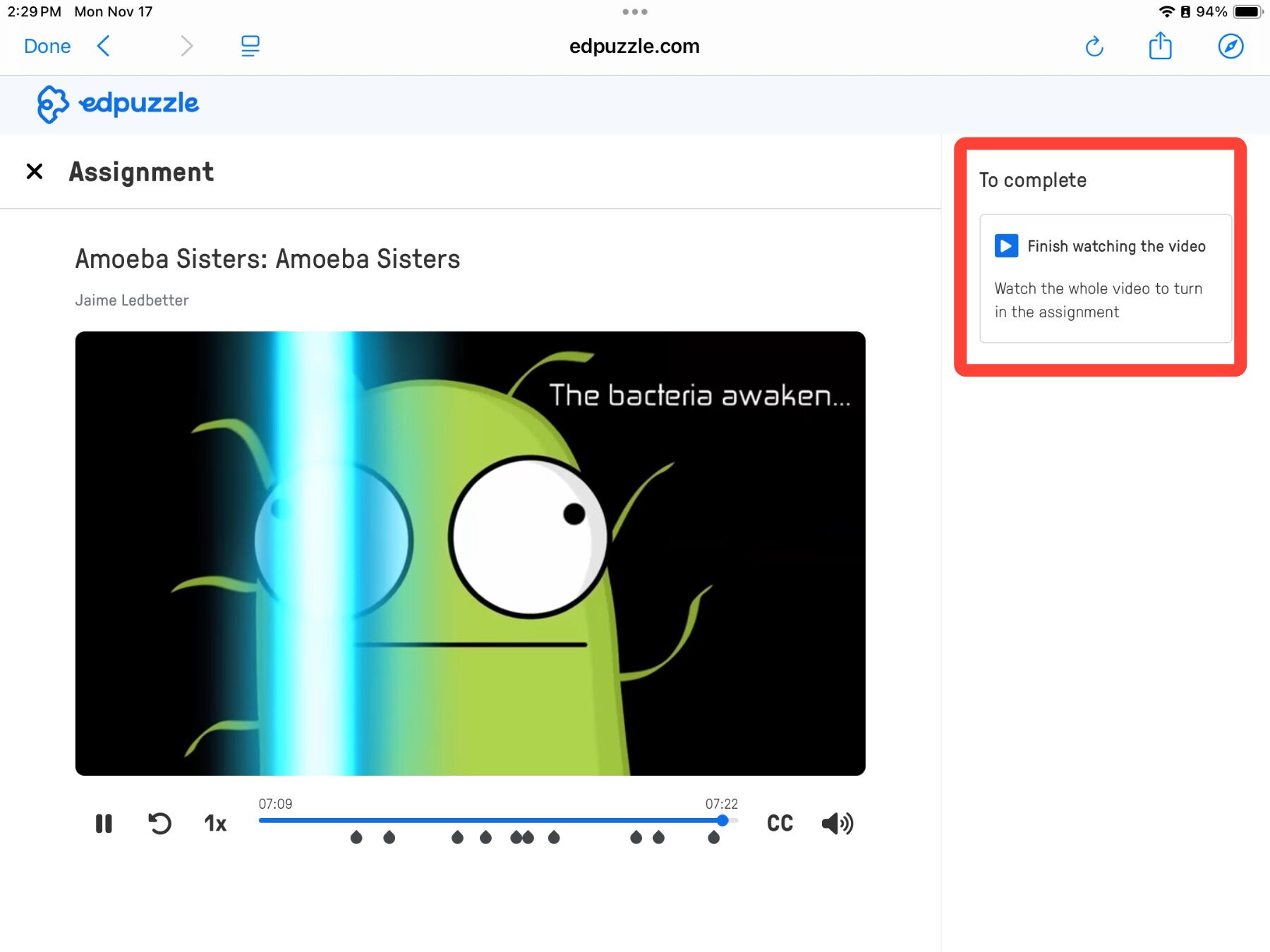 A cartoon green amoeba on a video screen with text reading, "The bacteria awaken." Checklist shows "Finish watching the video."